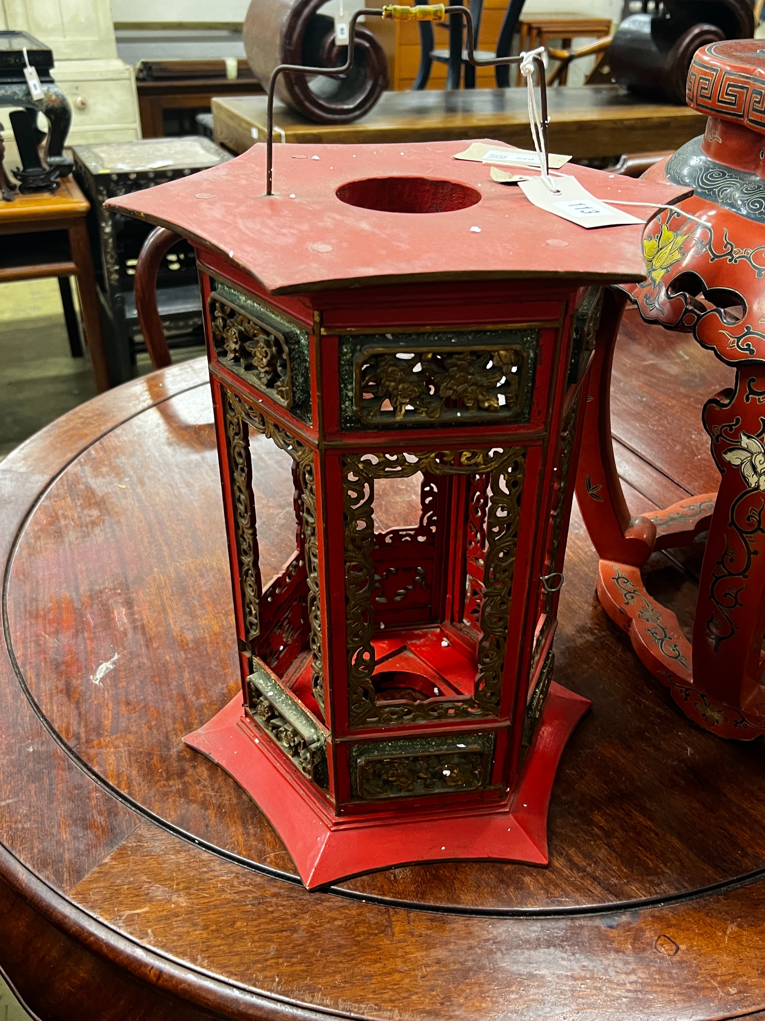 A Chinese red lacquer circular vase stand, diameter 44cm, height 47cm together with a similar Chinese red painted parcelgilt lantern, height 41cm